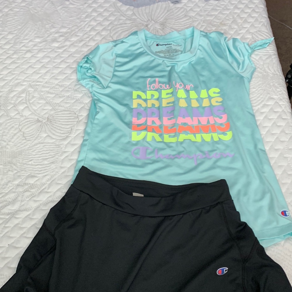 Teal shirt with a black skirt champion